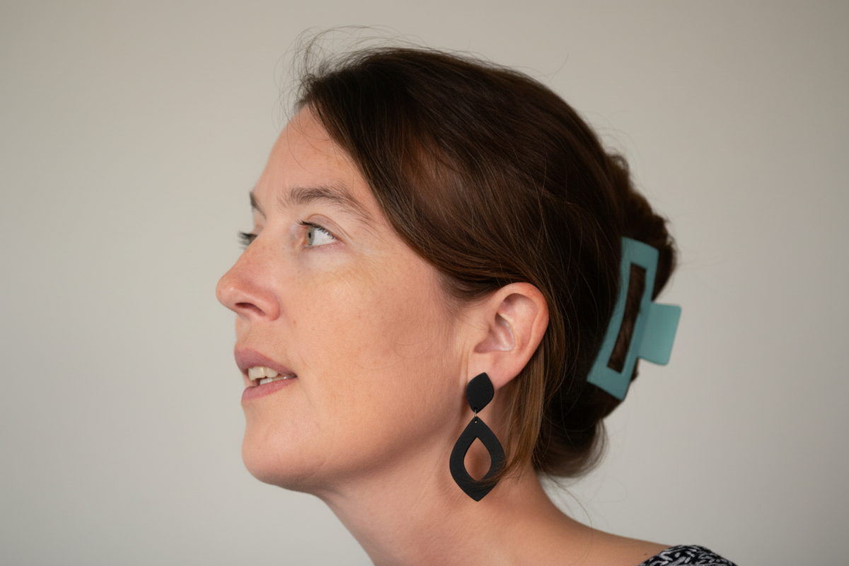 Woman wearing black earrings with a blurred background